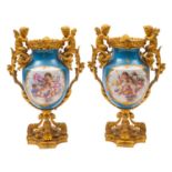 A pair of 19th century French ormolu-mounted porcelain urns decorated in the Sevres manner with