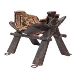 A Near Eastern stained wood and metal mounted camel saddle frame,