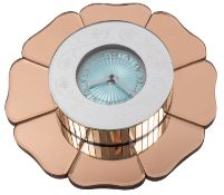 An Art Deco electric wall clock with pink scalloped edge mirrored surround,