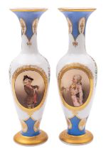 A pair of French opaline glass vases painted with pendant floral sprays and oval panels of young