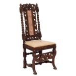 A late 19th-century carved oak chair in Charles II style;