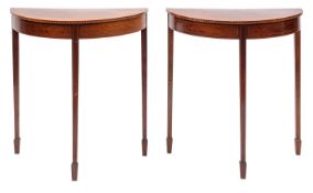 A pair of Edwardian mahogany and inlaid demi-lune pier tables;