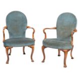 A pair of walnut and upholstered elbow chairs in George II style,