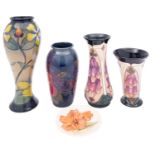 Four John Moorcroft vases and a pin tray, comprising two tube lined in the Foxglove pattern,