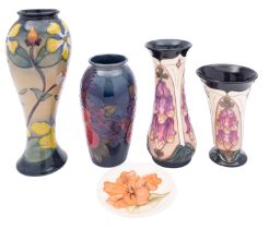 Four John Moorcroft vases and a pin tray, comprising two tube lined in the Foxglove pattern,
