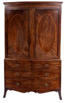 A George III mahogany bow fronted linen press; last quarter of the 18th century;