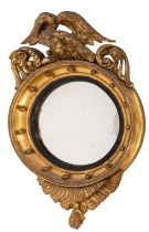 A Regency carved giltwood circular convex wall mirror;