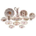 A collection of Dresden porcelain painted with floral sprays within gilt borders,