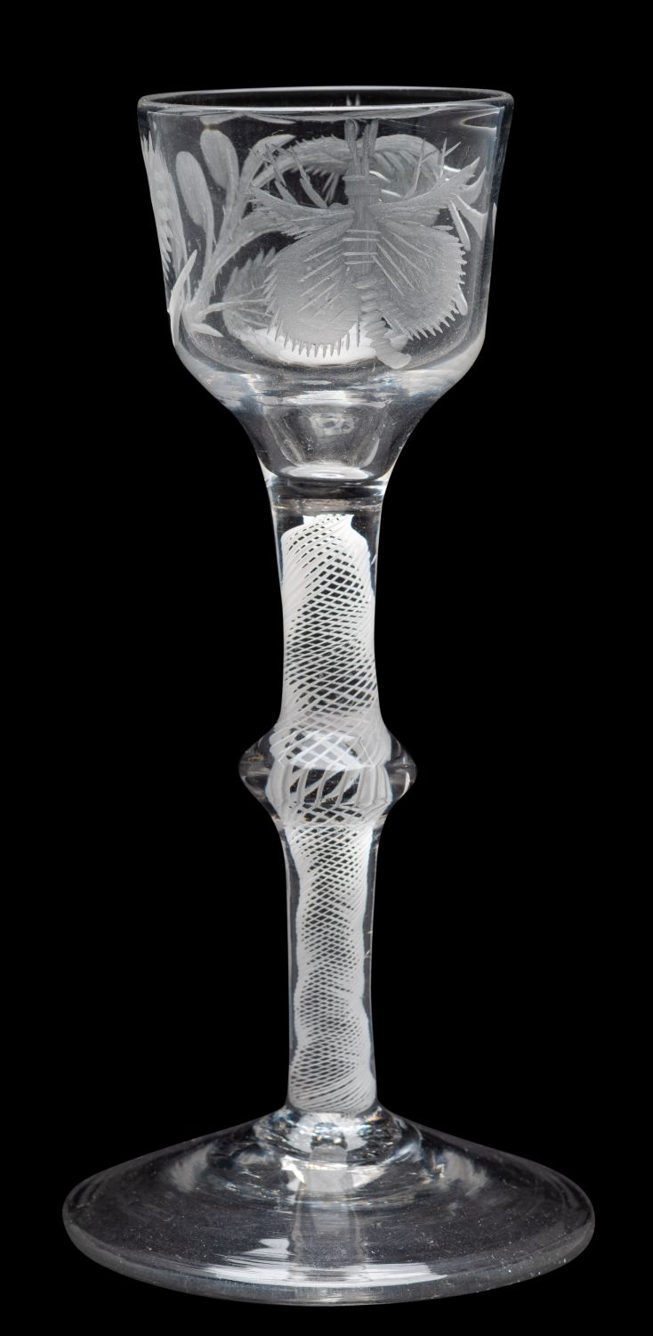 An opaque twist wine glass of Jacobite interest the ogee shaped bowl engraved with a rosebud and