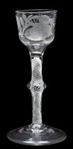 An opaque twist wine glass of Jacobite interest the ogee shaped bowl engraved with a rosebud and