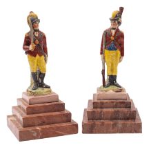 A pair of Staffordshire pearlware figures of a Hussar and a rifleman wearing red coats,
