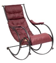 A wrought iron and burgundy leather upholstered rocking chair, by Peter Cooper for R. W.