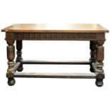 A 17th-century oak rectangular serving table, with a later top; with a fluted foliate frieze,