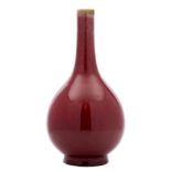 A Chinese sang-de-boeuf bottle vase with globular body, the glaze falling short of the slender neck,