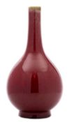 A Chinese sang-de-boeuf bottle vase with globular body, the glaze falling short of the slender neck,