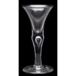 A baluster wine glass with bell shaped bowl set on an inverted baluster stem containing a single