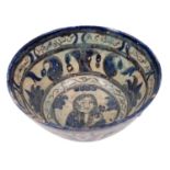 A Persian pottery bowl decorated in blue and grey with bands and panels of portraits,