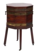 A George III mahogany and brass bound octagonal wine cooler, on a stand,