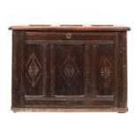 A 17th-century oak rectangular coffer; with a plain triple paneled hinged top,
