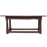 A mid 17th-century oak rectangular serving table; frieze with incised carved scrolling foliage,