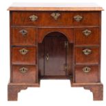 A walnut and feather banded kneehole desk, 18th Century and later,