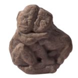 A carved stone group, Central/South American, modelled as an embracing couple, 30cm high.