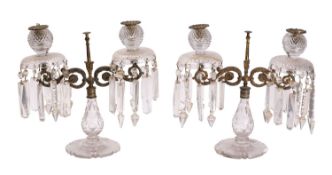 A pair of Regency cut glass and ormolu mounted twin light table lustres,