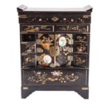 A Japanese inlaid and decorated black and gold lacquer table cabinet; with hinged top,