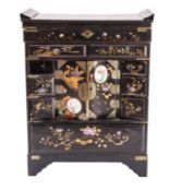 A Japanese inlaid and decorated black and gold lacquer table cabinet; with hinged top,