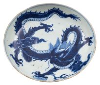 A Chinese blue and white 'dragon' saucer dish the interior painted with a dragon clasping a sacred