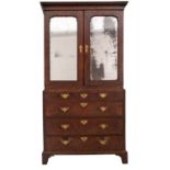 A George I walnut and feather banded cabinet on chest, the upper part with a moulded cornice,
