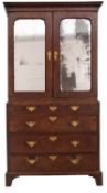 A George I walnut and feather banded cabinet on chest, the upper part with a moulded cornice,