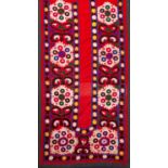 A North East Persian silk bed cover embroidered in the form of a prayer arch with panels of