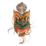 A South East Asian carved and painted wood mask;