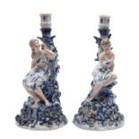 A pair of German porcelain figural candlesticks,