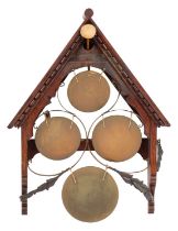 A set of Victorian oak and metal mounted wall mounting domestic gongs,