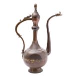 A large Middle Eastern copper alloy ewer of flattened bulbous form with slender neck and long