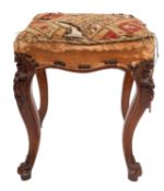 A Victorian carved square walnut stool; with an upholstered stuffover seat in needlework,