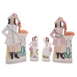 Two pairs of Staffordshire pottery figures,