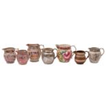 A group of seven early 19th century English pearlware and other earthenware jugs decorated in pink,