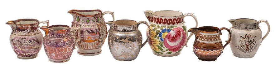 A group of seven early 19th century English pearlware and other earthenware jugs decorated in pink,