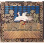 A Chinese silk and metal thread embroidered rank badge in the form of a phoenix amongst waves and