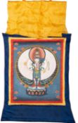 A Tibetan Thangka depicting Avalokiteshvara on a lotus throne, on cloth with red,
