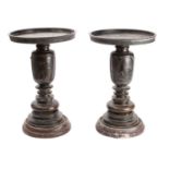 A pair of Japanese bronze vases in three parts, with circular flattened top sections,