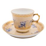 A Sevres Napoleon III porcelain cup and saucer painted in blue monochrome with flower sprays on a