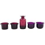A mixed group of amethyst coloured glass, including a ships decanter, wine glasses,