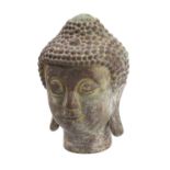 A Nepalese bronze head of Buddha with eyes downcast in contemplation, the hair in tight curls, 25cm.