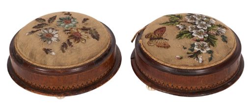 A pair of Victorian walnut and inlaid circular footstools;