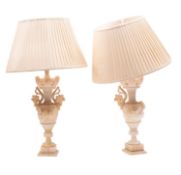 A pair of alabaster vase shaped table lamps; with wine leaf carved handles to each side,