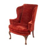A Queen Anne carved walnut wing frame armchair,